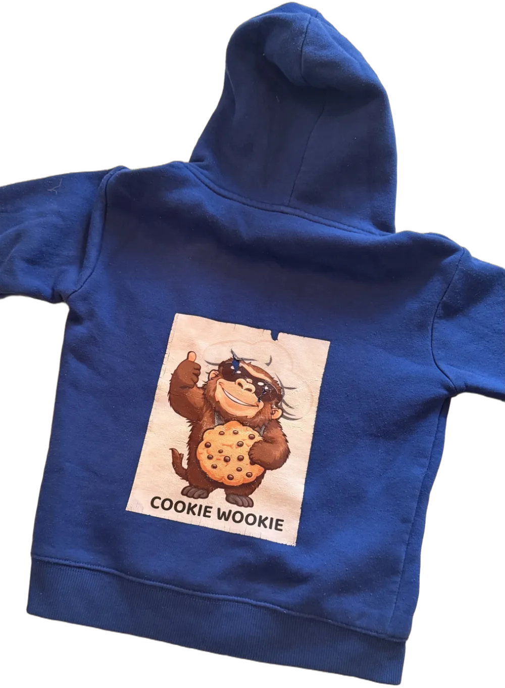 Royal blue Cookie Wookie hoodie, back, with Chewy giving a thumbs up and holding a chocolate chip cookie